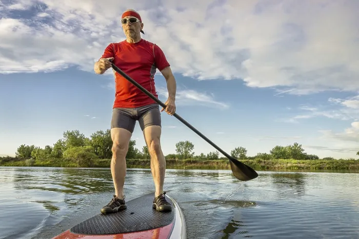 Framed Print : Senior muscular male paddler enjoying paddling on stand up paddleboard