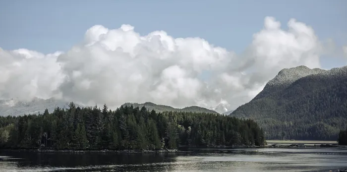 Framed Print : A serene view of mountains and forests reflected in a calm lake in Tofino