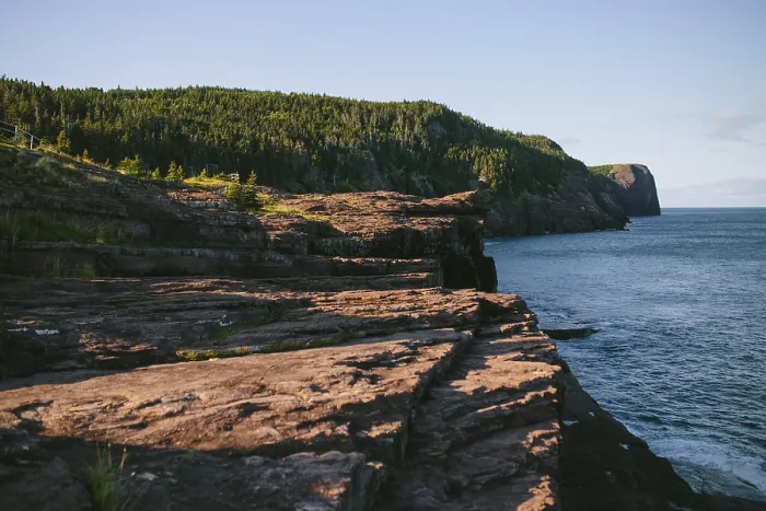 Framed Print : A serene view of the rugged cliffs descending into the ocean at Flatrock