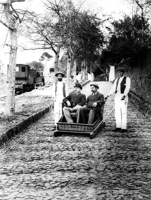 Framed Print : Service, two tourists are transported down a slope Framed Print : Service, two tourists are transported down a slope