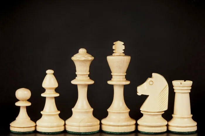 Framed Print : A set of wooden chess pieces including a king Framed Print : A set of wooden chess pieces including a king