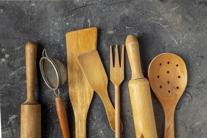 Framed Print : Set of wooden kitchen utensils on a blue background