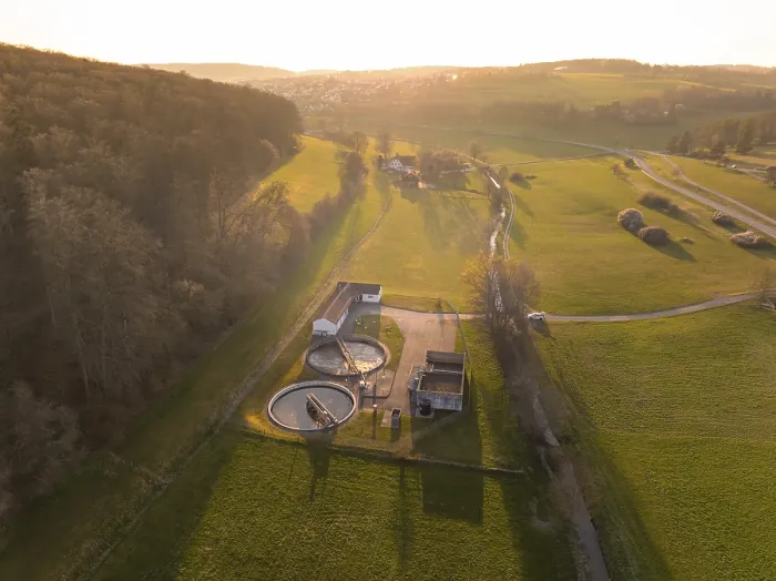 Framed Print : Sewage treatment plant between green fields and a forest