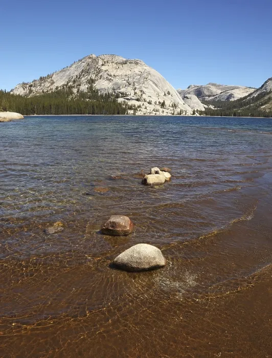 Framed Print : Shallow on the lake surrounded with mountains and woods