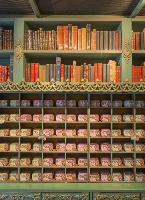 Framed Print : Shelf with antique books and colourful tins
