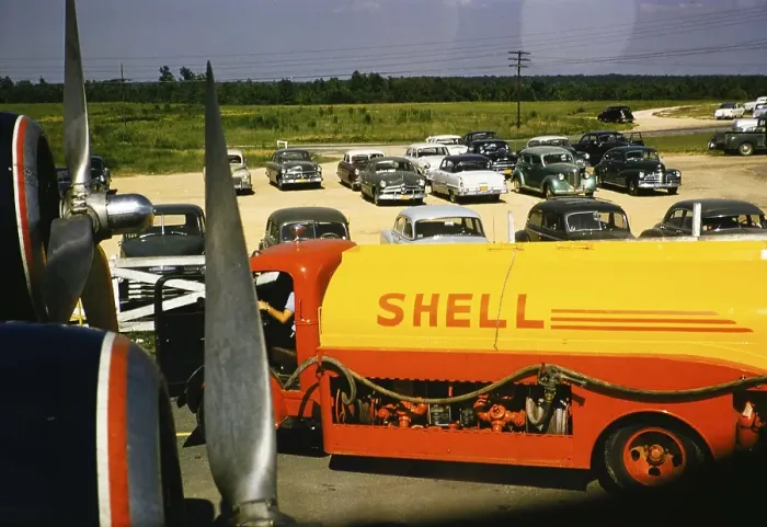 Framed Print : Shell oil tanker, seen through an aeroplane window with cars parked behind it, USA around 1953 Framed Print : Shell oil tanker, seen through an aeroplane window with cars parked behind it, USA around 1953
