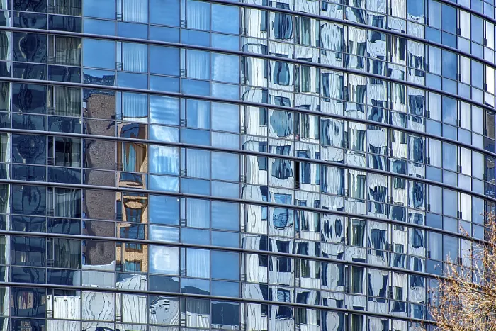 Framed Print : The shimmering blue, rounded, glass facade of a modern office tower Framed Print : The shimmering blue, rounded, glass facade of a modern office tower