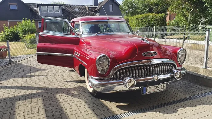 Framed Print : A shiny red vintage car with chrome details parked on a street on a sunny day
