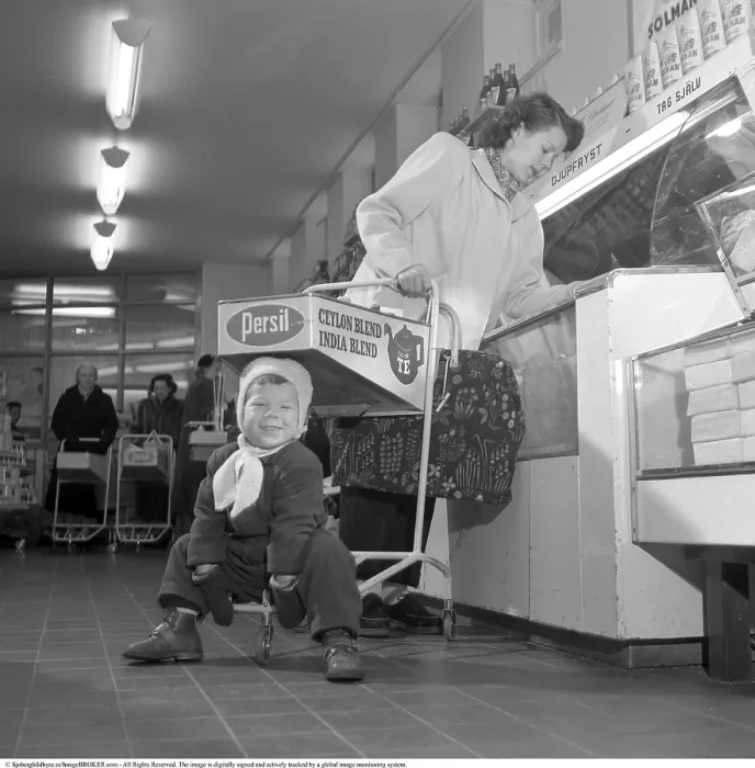 Framed Print : Shopping in the 1950s. A woman shops in a self service store