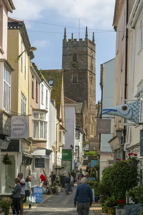 Framed Print : Shops in historic buildings along alleyway with tower of church of St Saviour