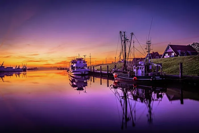 Framed Print : Shortly in front of sunrise in the harbour of Greetsiel with the anchored ships and reflection in the water, Greetsiel, Lower Saxony, Germany, Europe