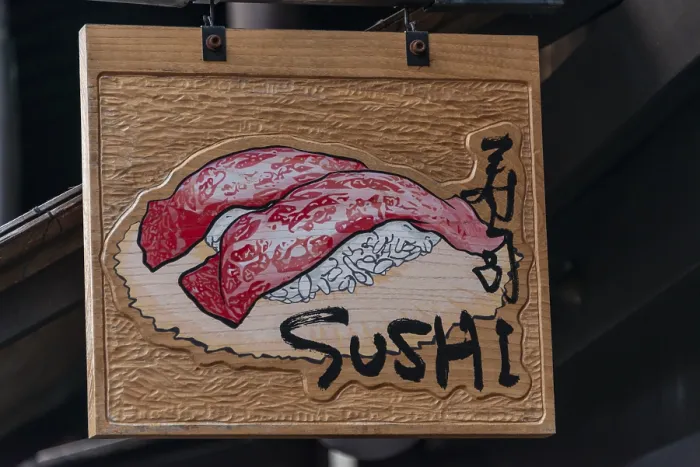 Framed Print : Signboard with inscription Sushi in front of a restaurant Framed Print : Signboard with inscription Sushi in front of a restaurant