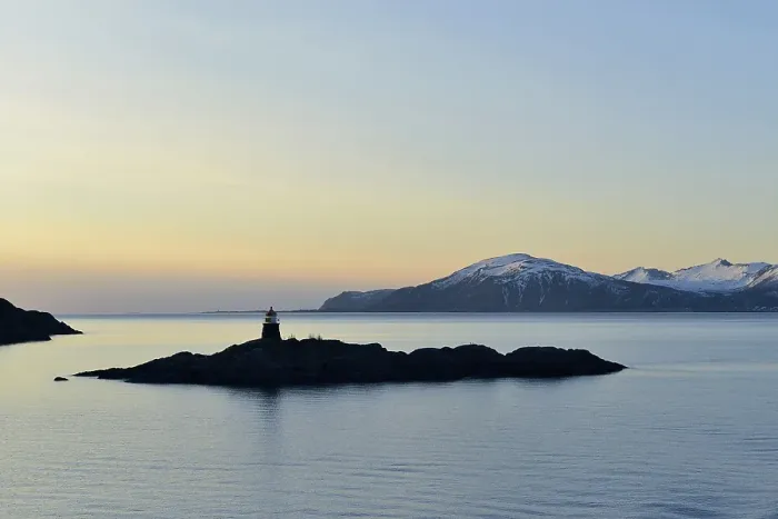 Framed Print : Silhouette of a small island with a lighthouse in the evening Framed Print : Silhouette of a small island with a lighthouse in the evening