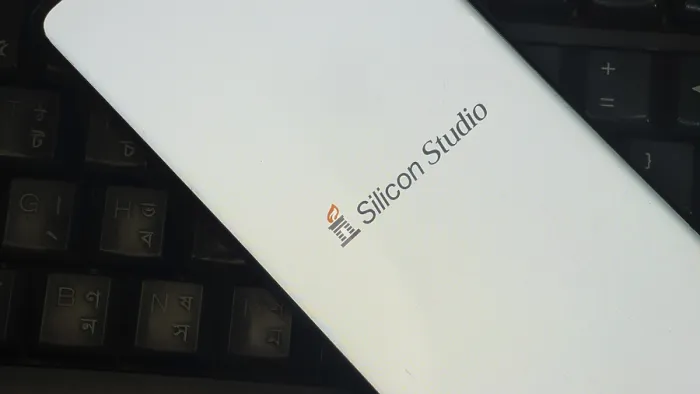 Framed Print : Silicon Studio logo on smartphone placed on a keyboard