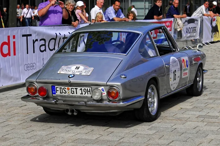 Framed Print : A silver classic car at a rally surrounded by an audience Framed Print : A silver classic car at a rally surrounded by an audience