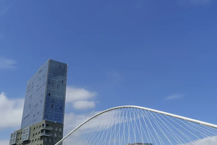 Framed Print : Single skyscraper, bridge, clouds in clear sky