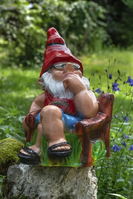 Framed Print : Sitting garden gnome in a garden Framed Print : Sitting garden gnome in a garden