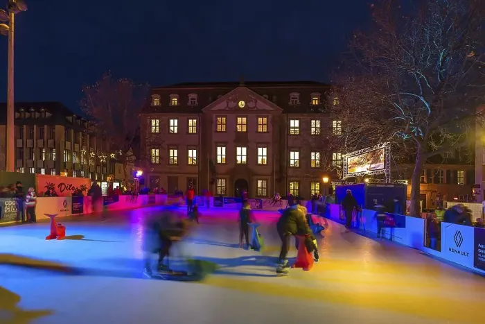 Framed Print : Skaters on a colourfully illuminated artificial ice rink Framed Print : Skaters on a colourfully illuminated artificial ice rink