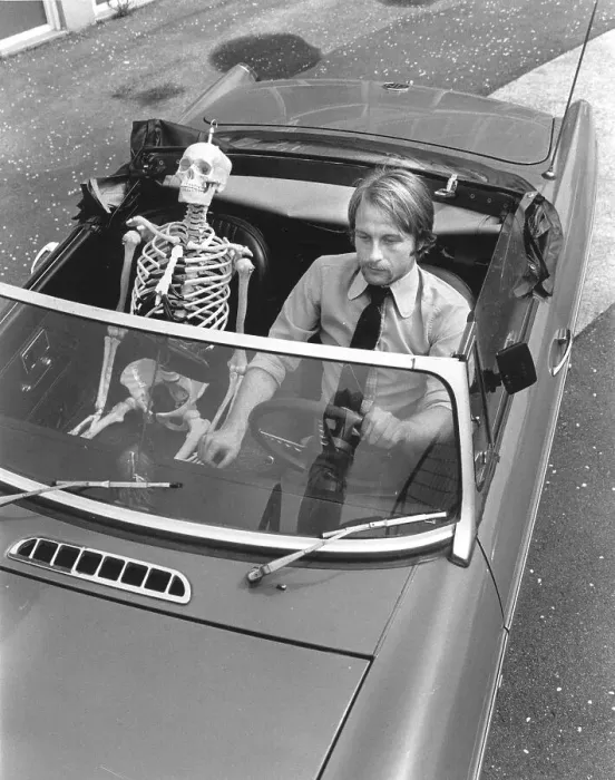Framed Print : Skeleton and man driving car, England