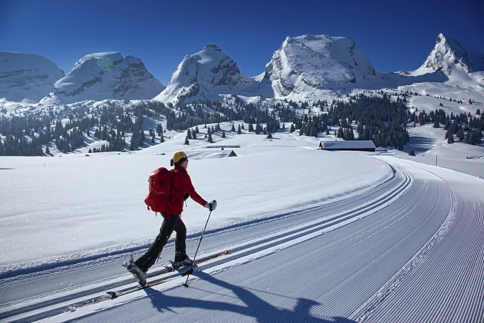 Framed Print : Ski tourer in a cross-country ski track climbing towards the Churfirsten under a clear blue sky Framed Print : Ski tourer in a cross-country ski track climbing towards the Churfirsten under a clear blue sky