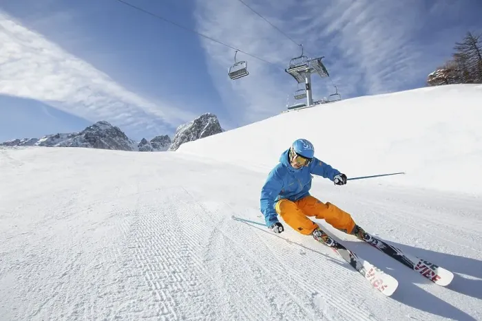 Framed Print : Skier with a helmet skiing down a slope
