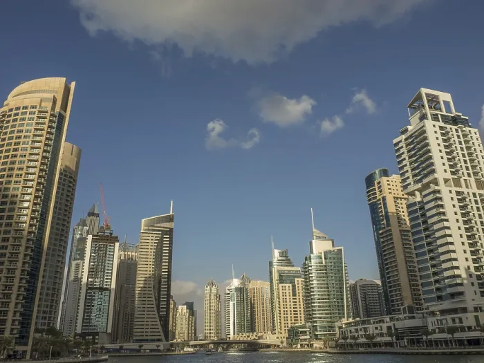 Framed Print : Skyscrapers of a modern city rise into the blue sky with few clouds