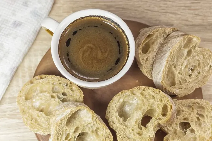 Framed Print : Sliced bread and a cup of coffee on a wooden board and linen tablecloth Framed Print : Sliced bread and a cup of coffee on a wooden board and linen tablecloth