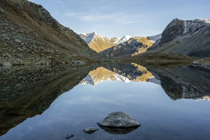 Framed Print : Slightly snow-covered mountains reflected in Schwarzsee in autumn on the Flueela Pass