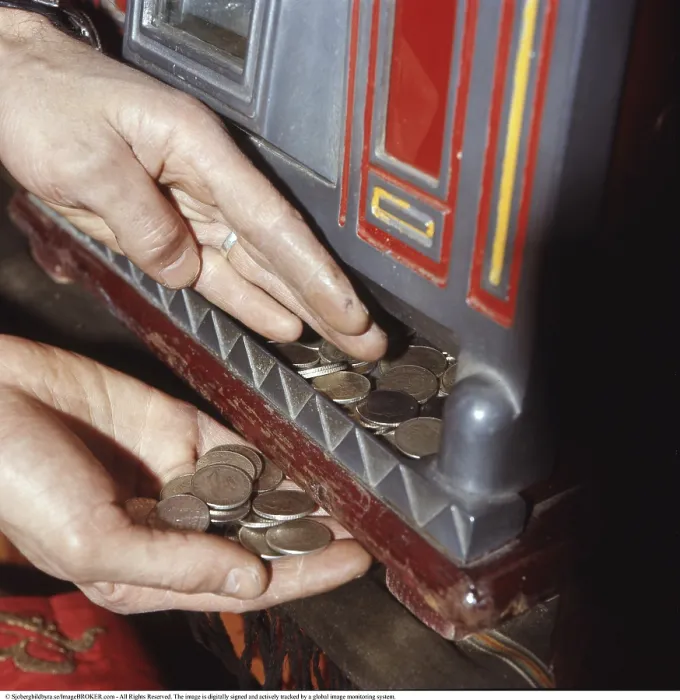 Framed Print : At the slot machine 1972. A person pictured at slot machine