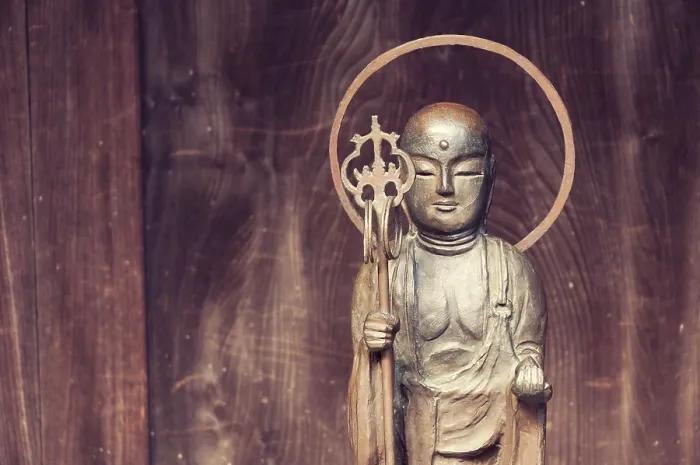 Framed Print : Small Buddha statue near wooden temple wall in Japan Framed Print : Small Buddha statue near wooden temple wall in Japan