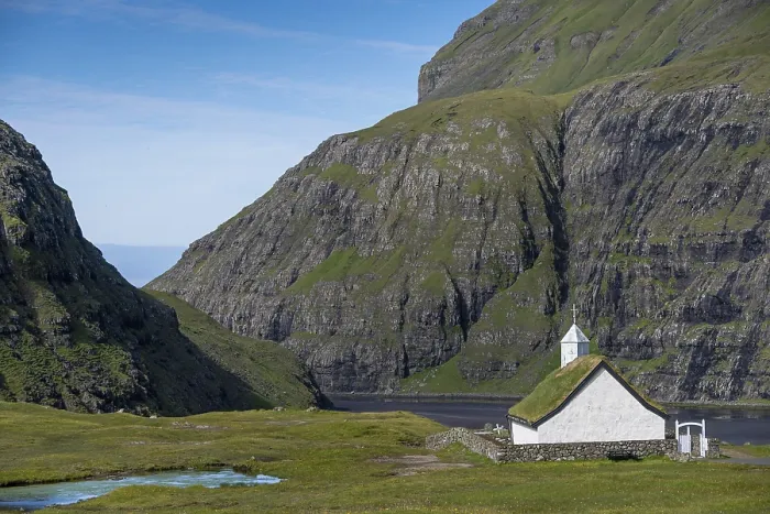 Framed Print : Small church with grass roof in mountain landscape