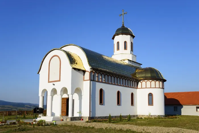 Framed Print : A small church with a white and gold facade under a blue sky looks peaceful and inviting