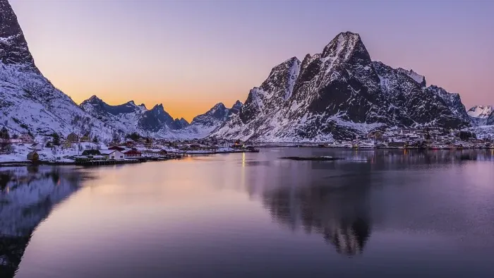 Framed Print : The small fishing village Reine on the Lofoten islands in Norway in winter with steep snowcapped mountains