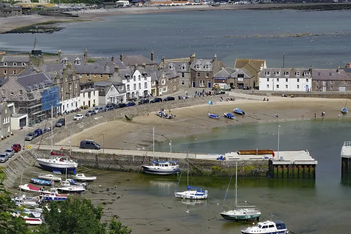 Framed Print : Small harbour with boats and surrounding houses on the coast