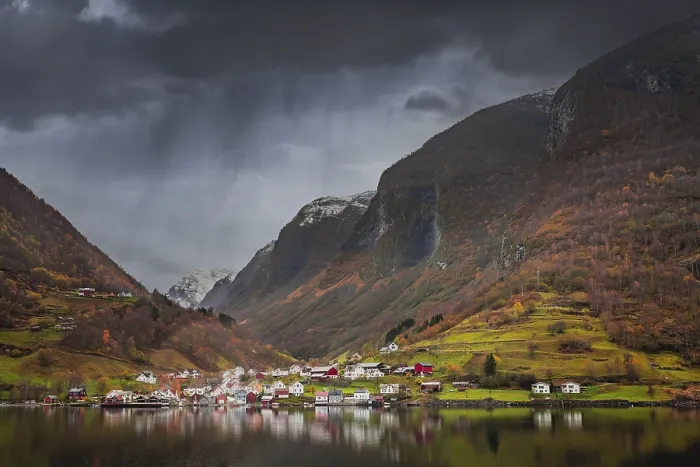 Framed Print : Small homes on the shore of a fjord photographed from a Fjords sightseeing cruise boat in autumn