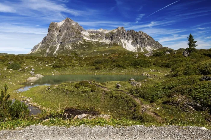 Framed Print : A small lake nestled in an alpine landscape with the distinctive GroBer Widderstein mountain