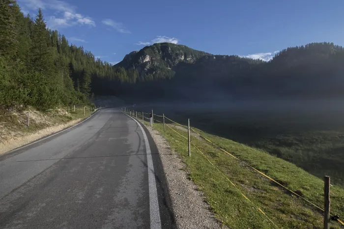 Framed Print : A small, light morning fog rising above the meadow by the asphalt road