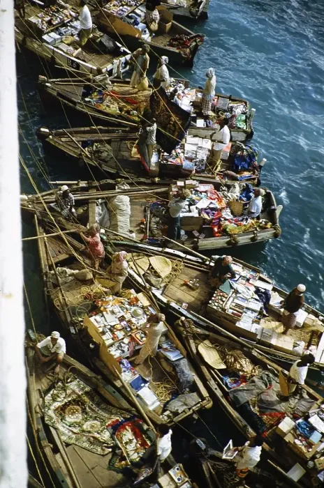Framed Print : Small open boats in which merchants sell souvenirs and products to the passengers of a ship, Aden, Yemen 1956