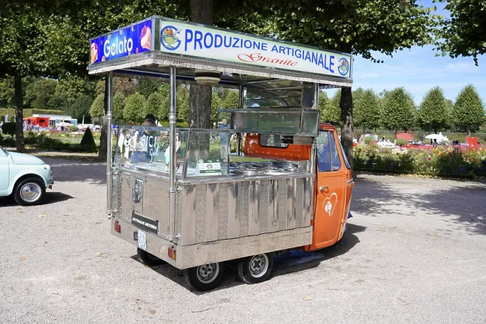 Framed Print : Small orange vending cart with open gelato area in a park