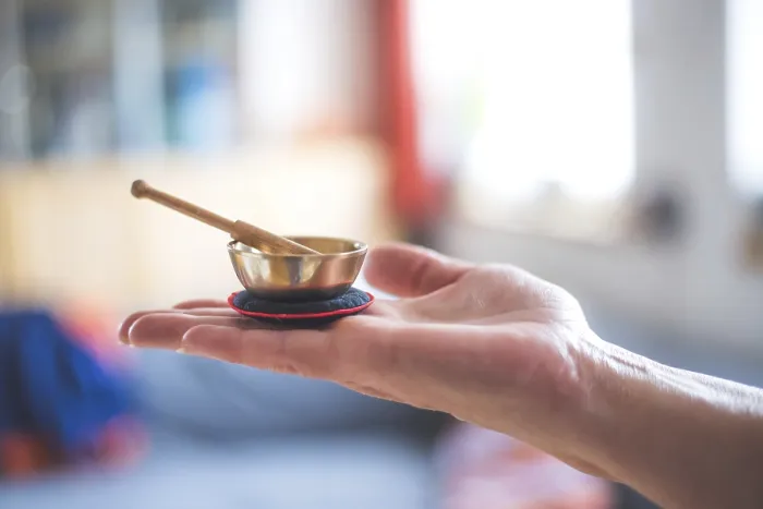 Framed Print : Small singing bowl holding in hand