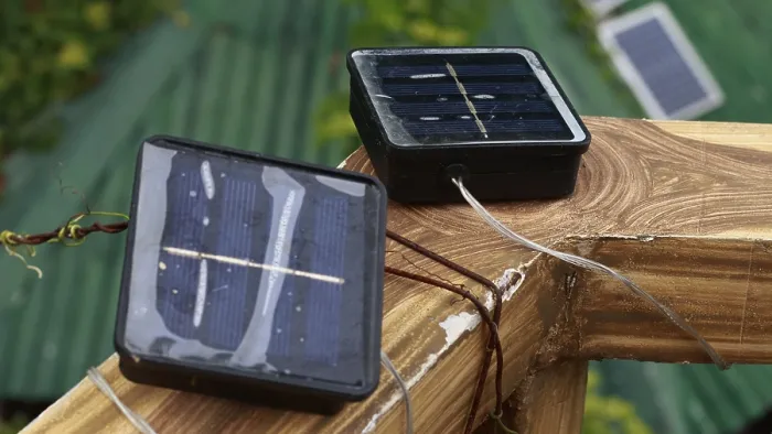 Framed Print : Small solar panels on a wooden surface with cables