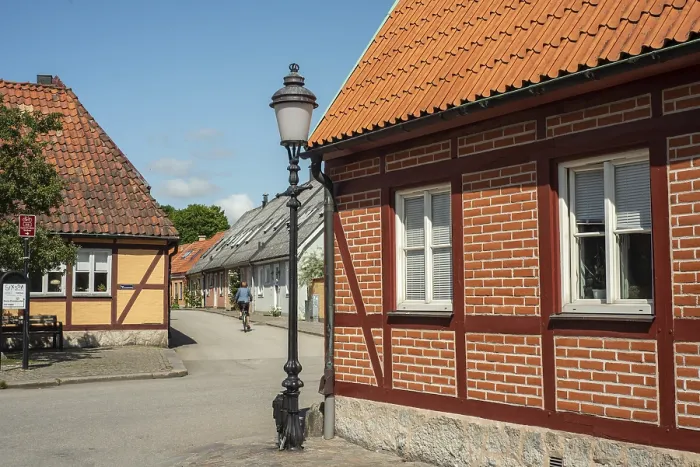 Framed Print : Small street with street lamp and half timbered house in Ystad
