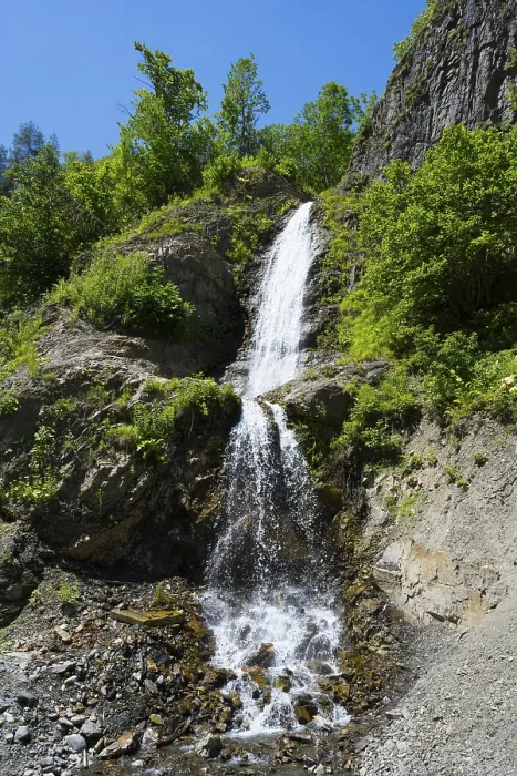 Framed Print : Small waterfall falling over green rocks