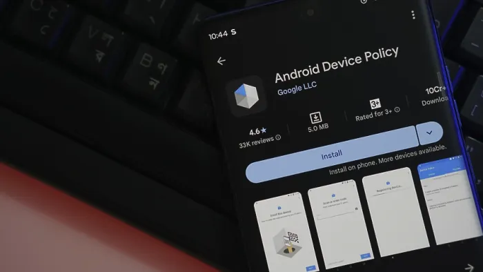 Framed Print : Smartphone app store screen displaying Android Device Policy ready to install on keyboard