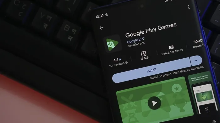 Framed Print : Smartphone displaying Google Play Games app installation page with a keyboard backdrop