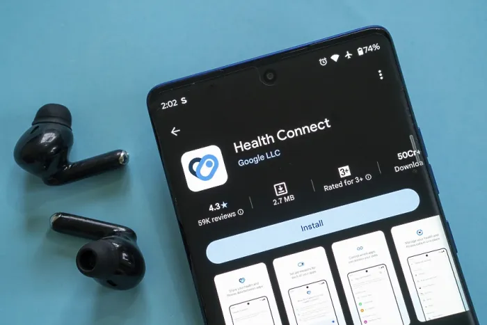 Framed Print : Smartphone displaying Health Connect app with black earbuds on a blue background Framed Print : Smartphone displaying Health Connect app with black earbuds on a blue background