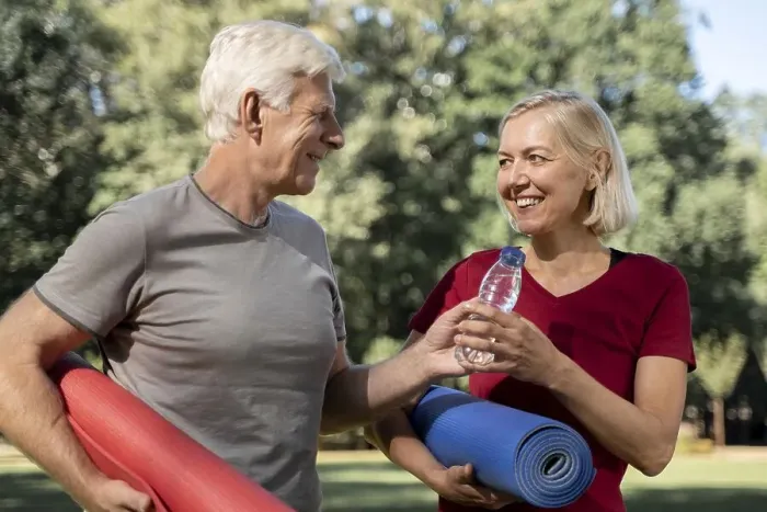 Framed Print : Smiley older couple outdoors with yoga mats water bottle Framed Print : Smiley older couple outdoors with yoga mats water bottle