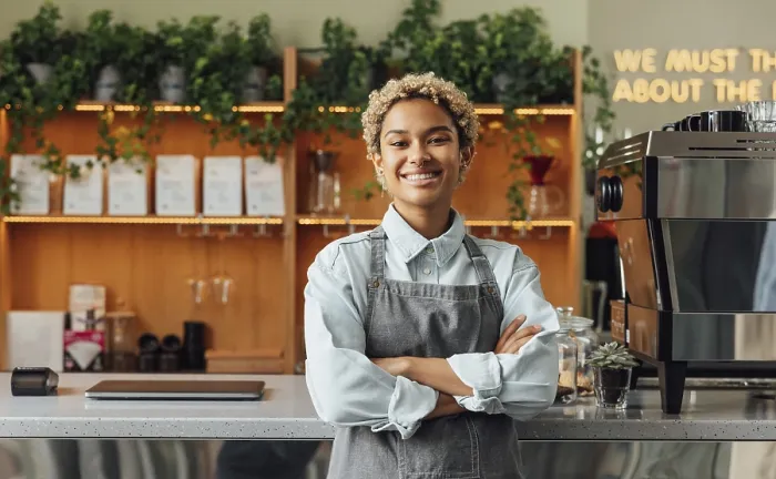 Framed Print : Smiling confident coffee shop owner at the counter