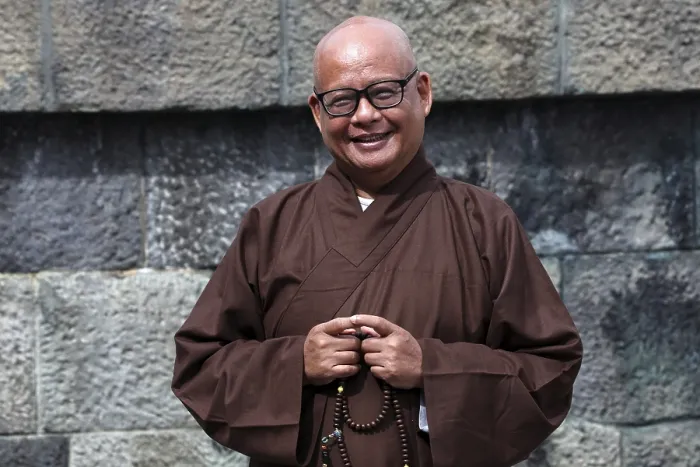 Framed Print : Smiling monk wearing traditional robe at Kotokuin Temple in Kamakura