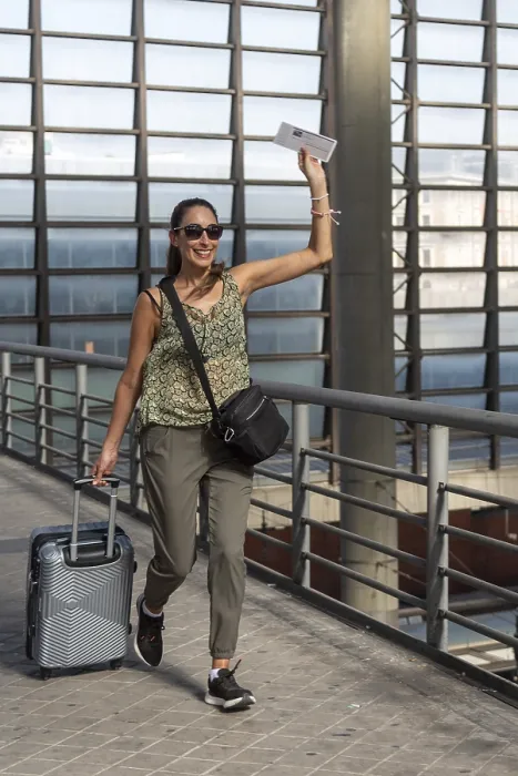 Framed Print : Smiling woman traveler pulling suitcase